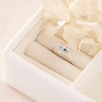 Silver ring with bee design in a white jewelry box