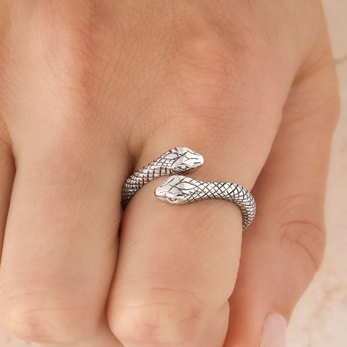 Silver snake-shaped ring on a finger
