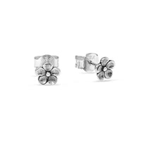 Silver flower-shaped earrings on a white background