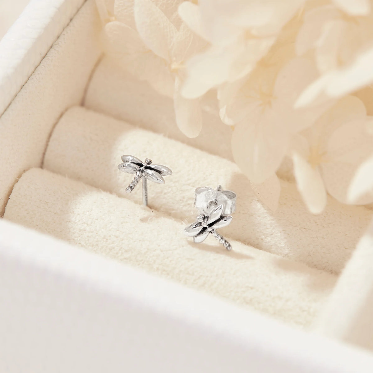 Silver Dragonfly earrings on a soft beige background